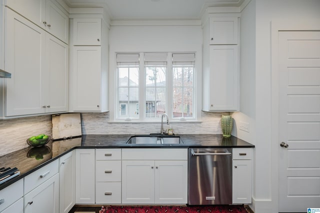 kitchen featuring stainless steel dishwasher, backsplash, white cabinetry, and sink