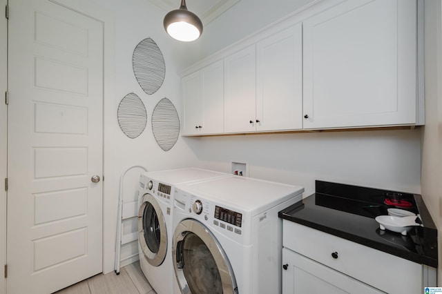 laundry area with washer and dryer, light tile patterned flooring, and cabinets