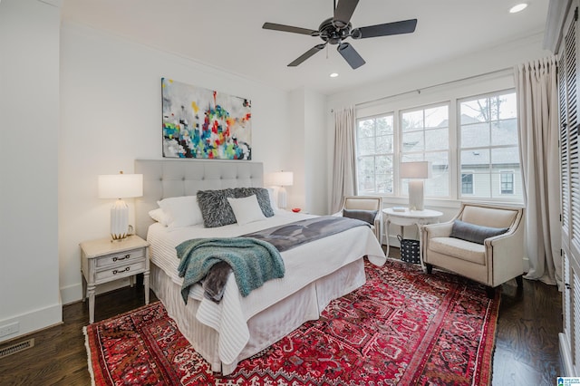 bedroom featuring dark hardwood / wood-style floors, ceiling fan, and crown molding