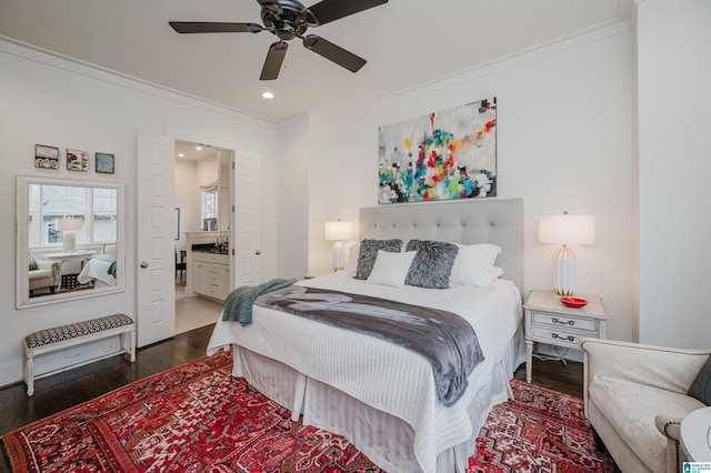 bedroom featuring ensuite bathroom, dark hardwood / wood-style flooring, ceiling fan, and ornamental molding