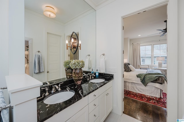 bathroom with ceiling fan, vanity, hardwood / wood-style flooring, and ornamental molding