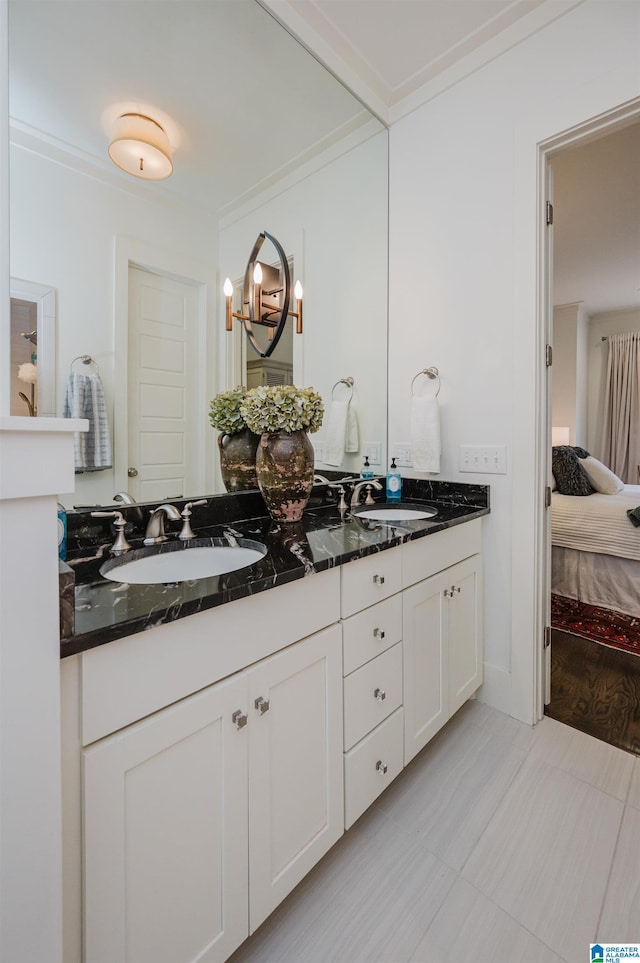 bathroom with tile patterned flooring, vanity, and crown molding