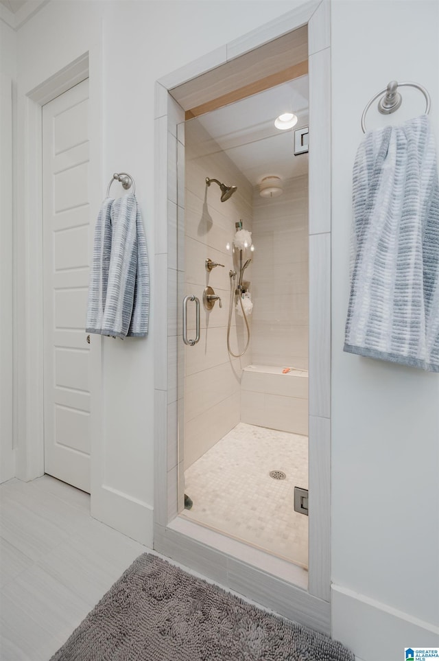 bathroom featuring a shower with shower door