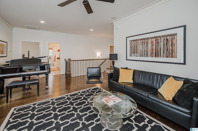 living room featuring dark hardwood / wood-style floors, ceiling fan, and ornamental molding