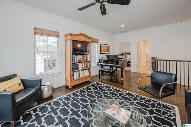 living area featuring ceiling fan, dark hardwood / wood-style flooring, and ornamental molding