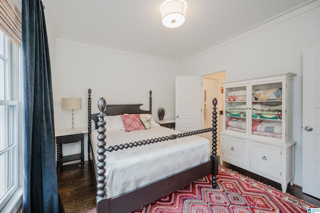 bedroom featuring dark hardwood / wood-style floors and ornamental molding