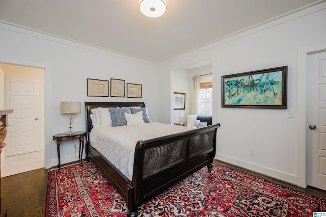 bedroom with dark hardwood / wood-style flooring and ornamental molding