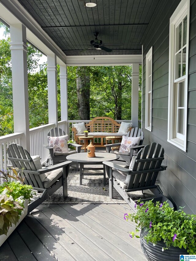 wooden deck with a porch and ceiling fan