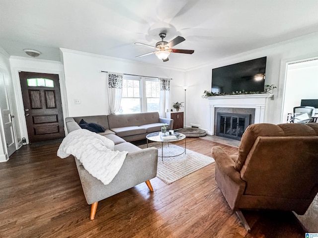 living room featuring dark hardwood / wood-style flooring, ceiling fan, and crown molding