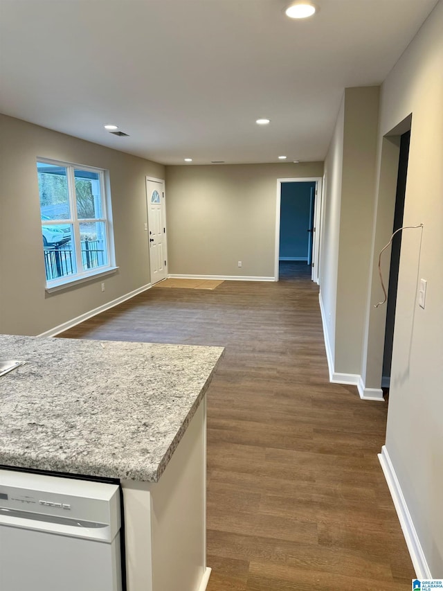 kitchen featuring dishwasher and dark hardwood / wood-style flooring