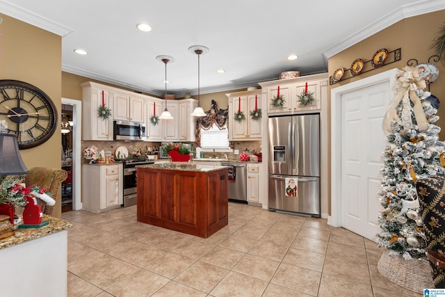 kitchen with light stone counters, backsplash, crown molding, pendant lighting, and appliances with stainless steel finishes