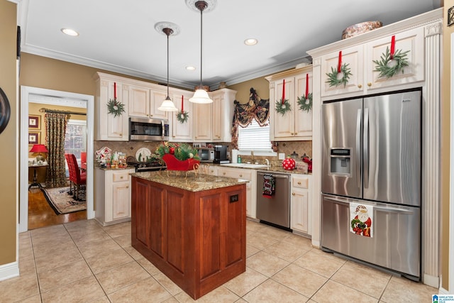 kitchen featuring backsplash, stainless steel appliances, stone counters, a kitchen island, and hanging light fixtures