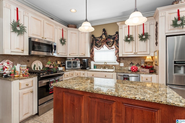 kitchen featuring decorative light fixtures, light tile patterned flooring, sink, and stainless steel appliances