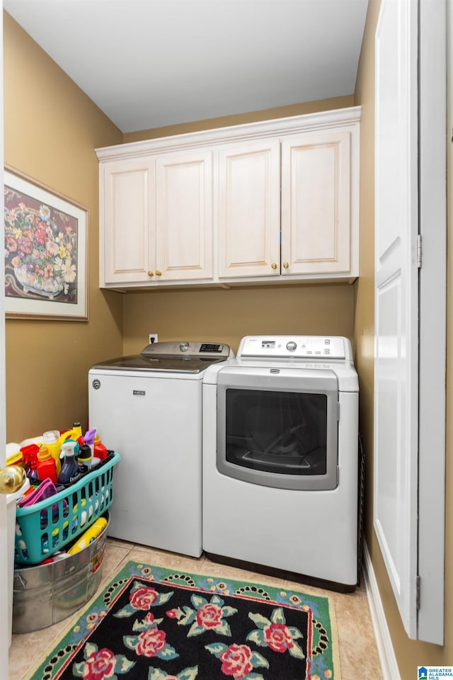 laundry room featuring separate washer and dryer and cabinets