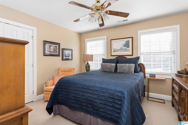 bedroom with ceiling fan and light carpet