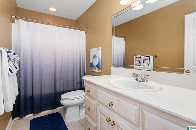 bathroom with tile patterned flooring, vanity, and toilet