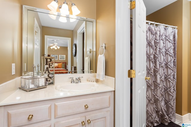 bathroom featuring curtained shower, vanity, and ceiling fan with notable chandelier