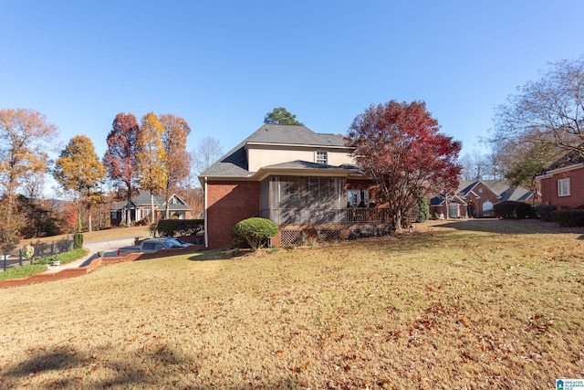 view of side of home with a lawn