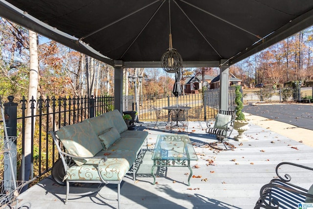 wooden deck featuring a gazebo and an outdoor hangout area