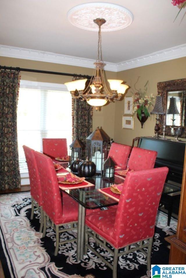 dining area featuring crown molding and a notable chandelier