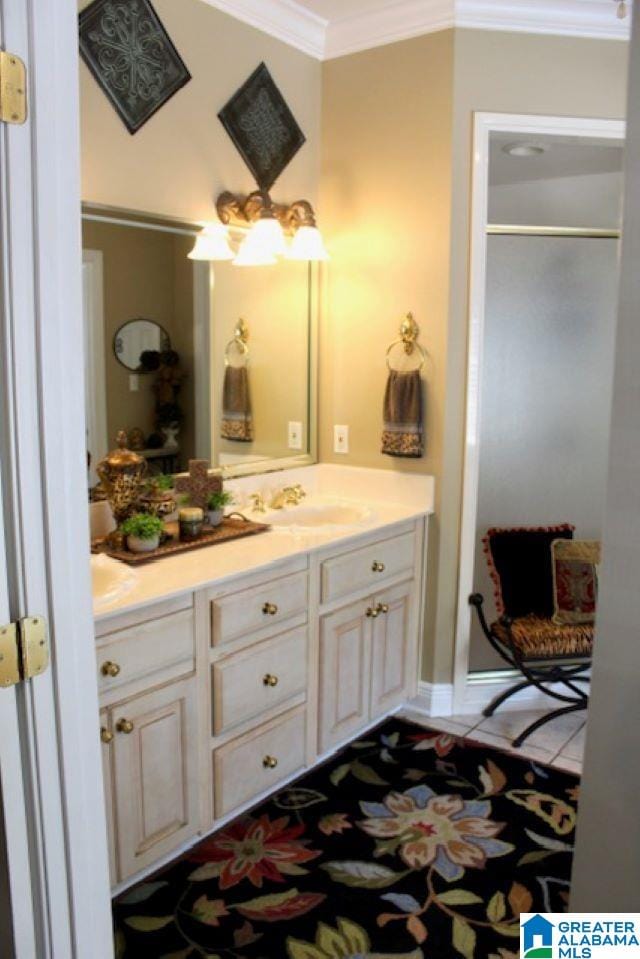 bathroom with vanity, an enclosed shower, and crown molding