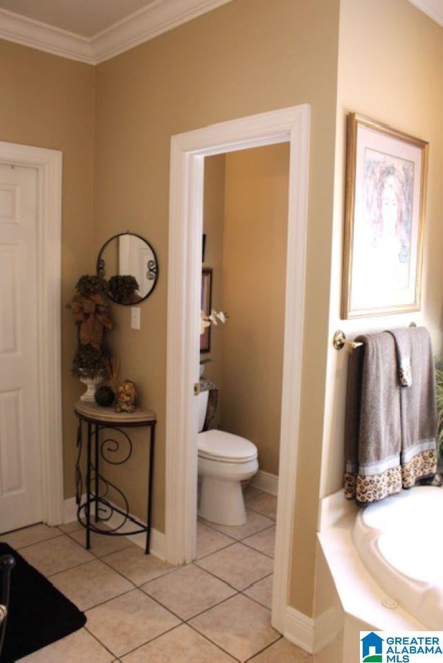 bathroom with crown molding, tile patterned flooring, and toilet