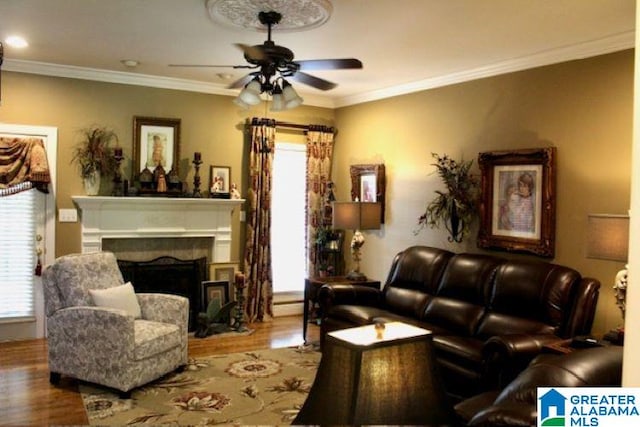 living room with crown molding, ceiling fan, and hardwood / wood-style flooring