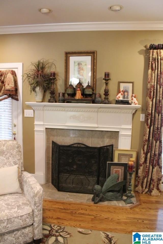 room details featuring crown molding, a fireplace, and hardwood / wood-style floors