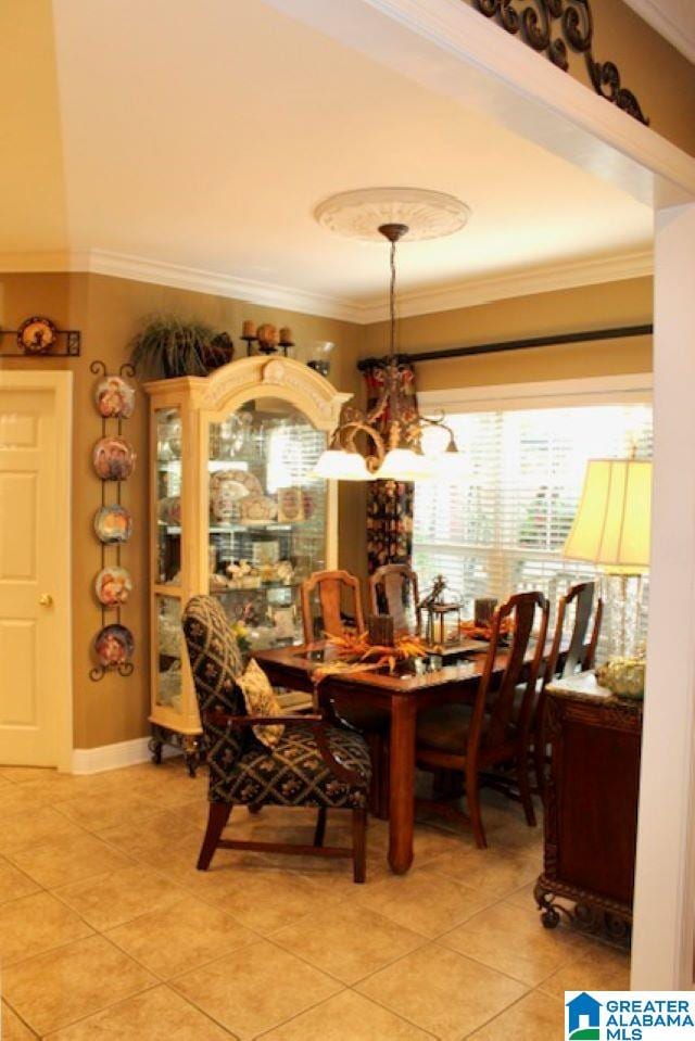 dining space featuring a notable chandelier, light tile patterned floors, and crown molding