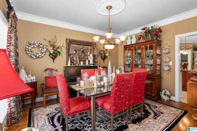 dining room with wood-type flooring, an inviting chandelier, and ornamental molding