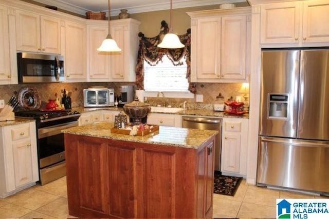 kitchen featuring sink, appliances with stainless steel finishes, tasteful backsplash, decorative light fixtures, and light stone counters