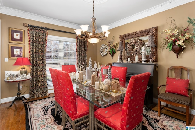 dining area with wood-type flooring, crown molding, and an inviting chandelier