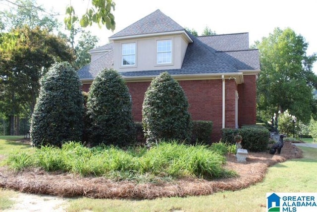 view of side of home with a lawn