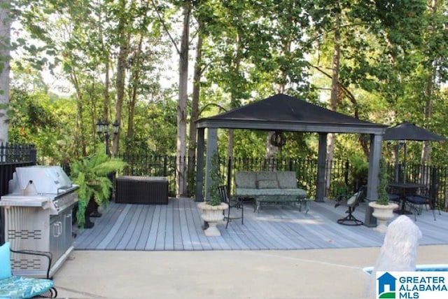 view of patio with a gazebo, a grill, an outdoor living space, and a deck