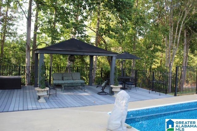 view of pool featuring a gazebo, a deck, and outdoor lounge area