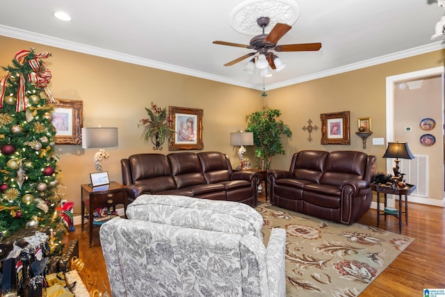 living room featuring hardwood / wood-style flooring, ceiling fan, and ornamental molding