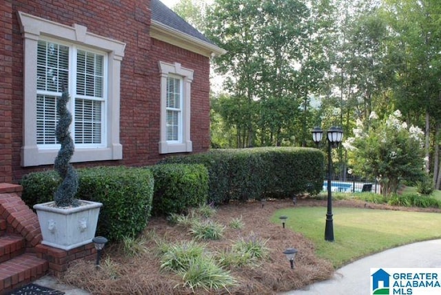 view of side of home with a lawn