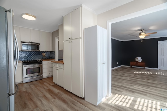 kitchen featuring backsplash, stainless steel appliances, white cabinetry, and light hardwood / wood-style floors