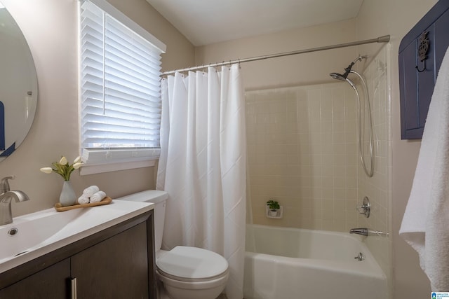 full bathroom featuring shower / bath combination with curtain, vanity, and toilet