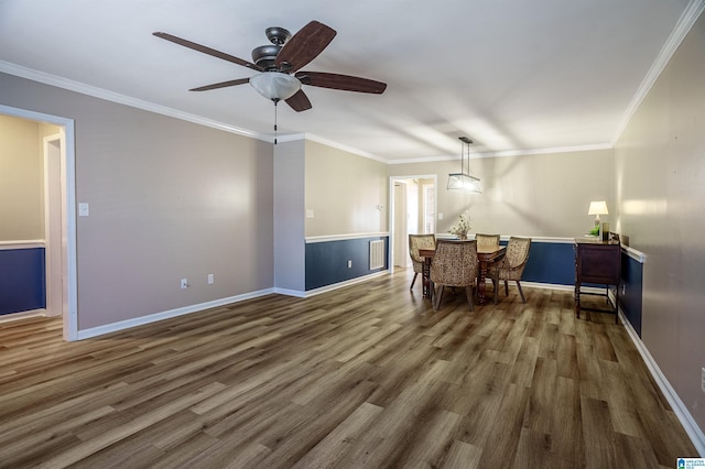 dining space with dark hardwood / wood-style floors, ceiling fan, and crown molding