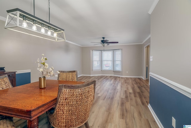 dining space with ceiling fan, wood-type flooring, and ornamental molding