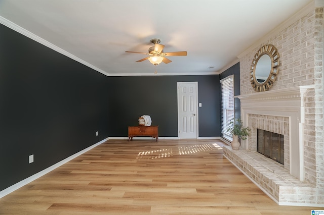 unfurnished living room featuring a brick fireplace, ceiling fan, light hardwood / wood-style floors, and ornamental molding