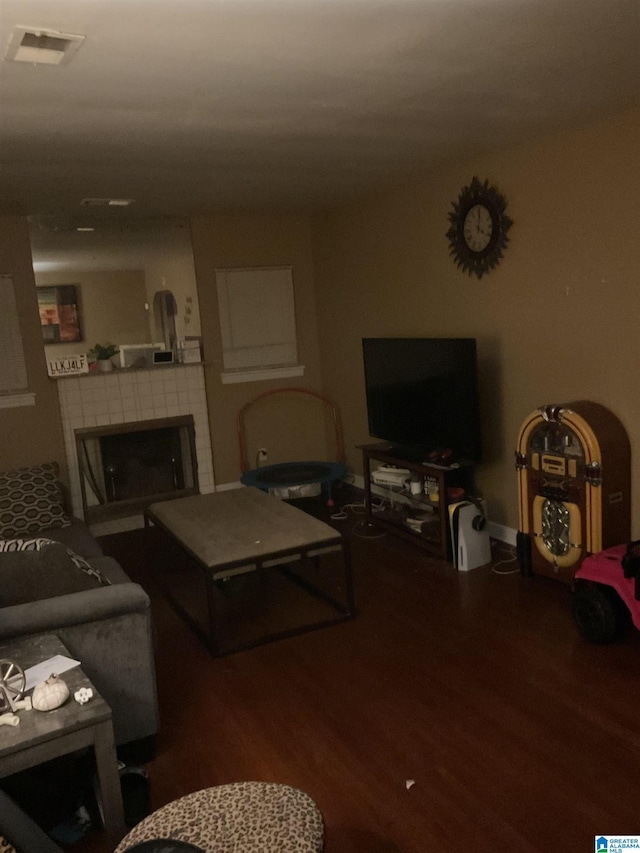 living room featuring a fireplace and dark hardwood / wood-style flooring