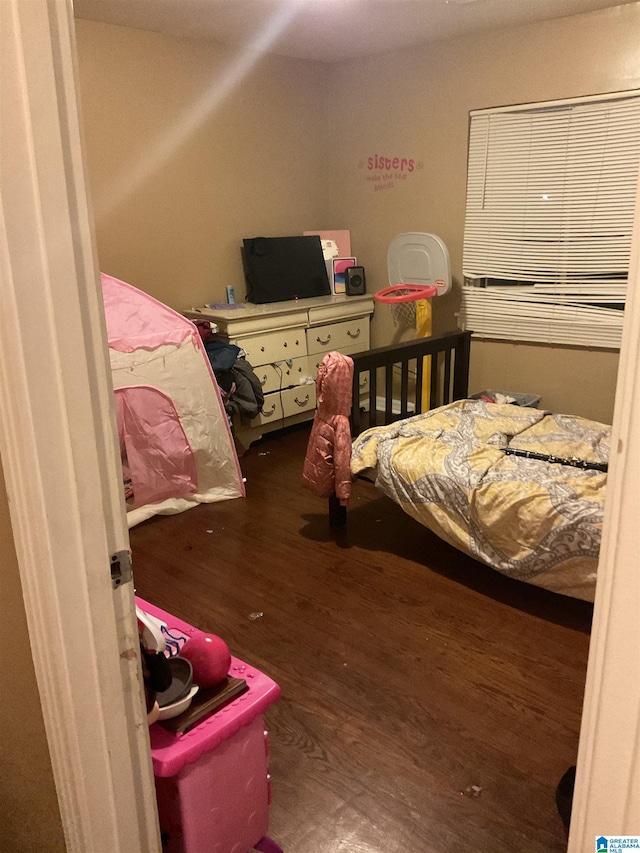 bedroom with dark hardwood / wood-style flooring