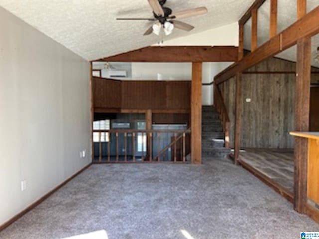 unfurnished living room featuring a textured ceiling, ceiling fan, carpet floors, and vaulted ceiling