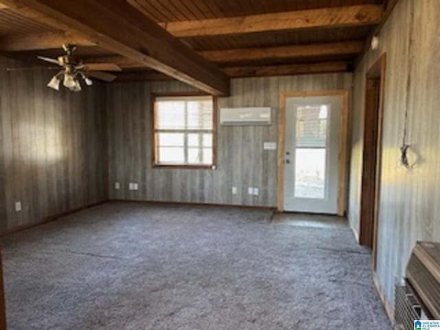 unfurnished living room with a wall mounted air conditioner, beam ceiling, wooden ceiling, and wood walls