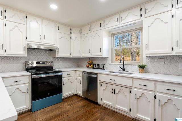 kitchen with dark hardwood / wood-style flooring, white cabinetry, sink, and stainless steel appliances