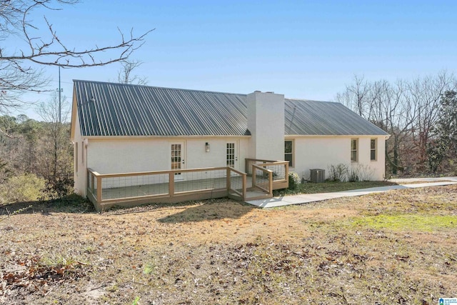 view of front of home with a wooden deck and cooling unit