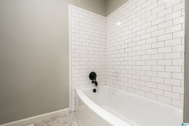 bathroom with tile patterned flooring and shower / bath combination