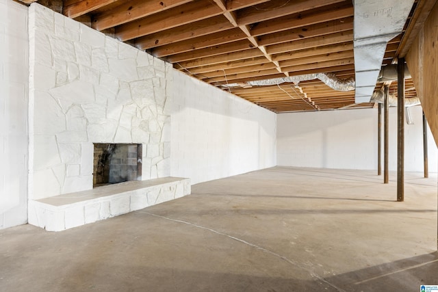 basement featuring a stone fireplace